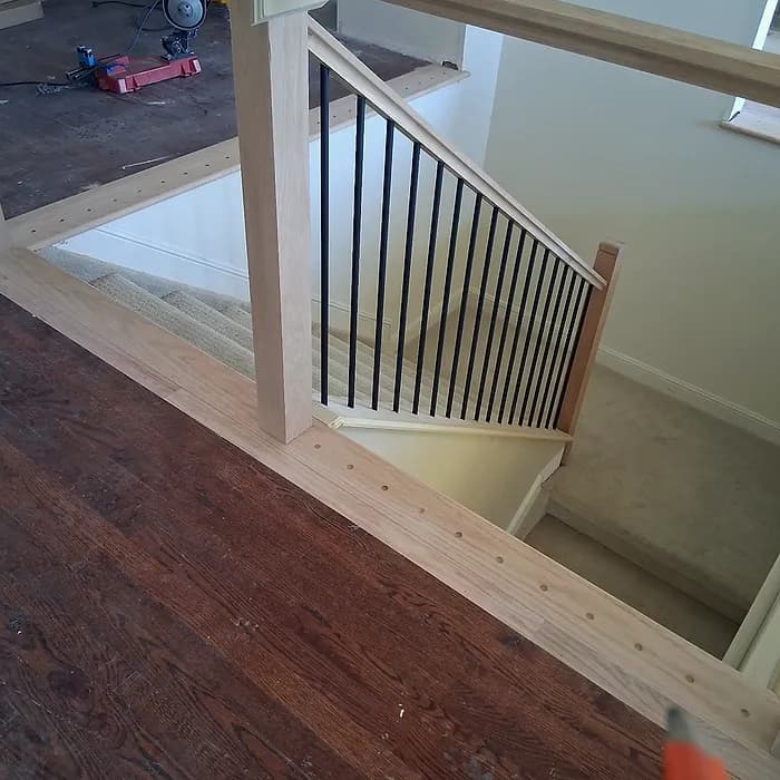Second-floor landing railing with iron balusters