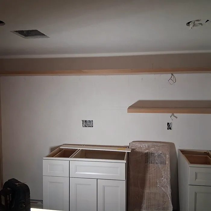 Kitchen cabinetry paired with floating wood shelves